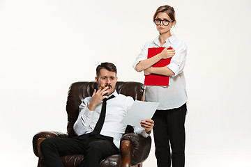 Image showing The young man and beautiful woman in business suit at office on white background