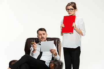 Image showing The young man and beautiful woman in business suit at office on white background