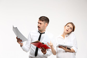 Image showing The business man and woman communicating on a gray background