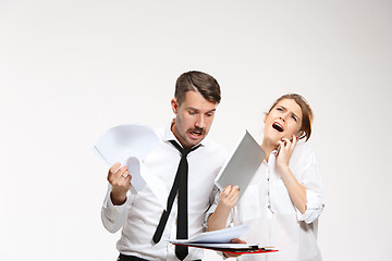 Image showing The business man and woman communicating on a gray background