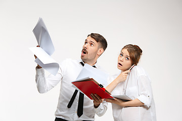 Image showing The business man and woman communicating on a gray background