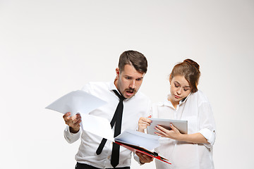 Image showing The business man and woman communicating on a gray background