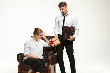 Image showing The young man and beautiful woman in business suit at office on white background