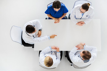 Image showing doctor showing something imaginary on table