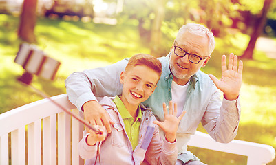 Image showing old man and boy taking selfie by smartphone