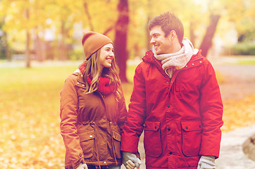 Image showing happy young couple walking in autumn park