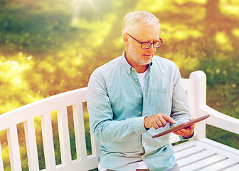 Image showing senior man with tablet pc at summer park