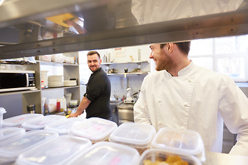 Image showing chef and cook cooking food at restaurant kitchen