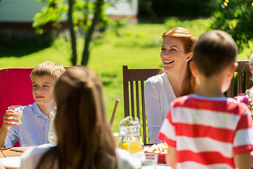 Image showing happy family having dinner or summer garden party