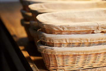 Image showing bakery wicker baskets on wooden kitchen table