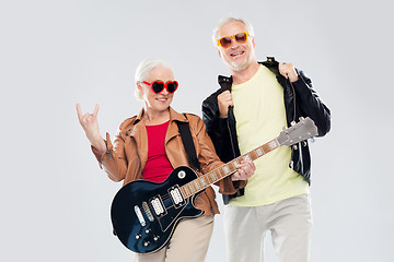 Image showing senior couple with guitar showing rock hand sign