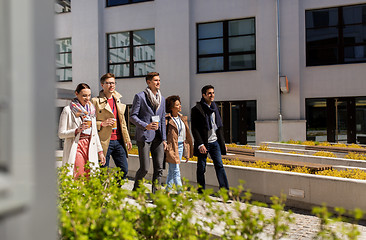 Image showing people with coffee and conference badges in city