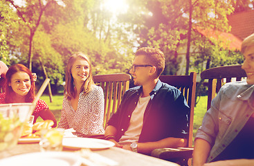 Image showing happy friends having dinner at summer garden party