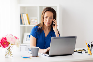 Image showing woman calling on smartphone at office or home