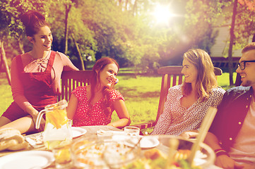 Image showing happy friends having dinner at summer garden party