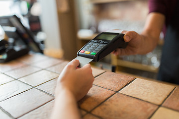 Image showing hands with payment terminal and credit card