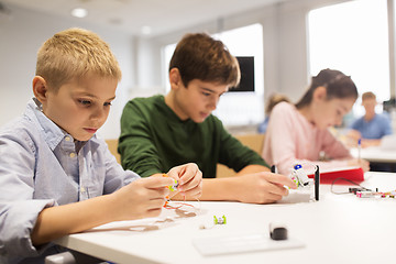 Image showing happy children building robots at robotics school