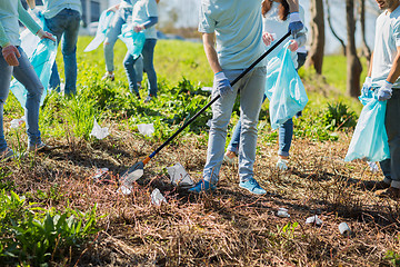 Image showing volunteers with garbage bags cleaning park area