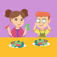 Image showing Caucasian boy and girl playing with vegetables.