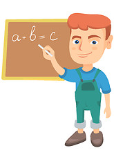 Image showing Caucasian schoolboy writing on the blackboard.