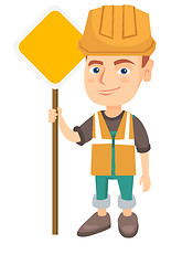 Image showing Little caucasian builder boy holding road sign.