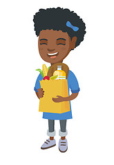 Image showing Girl holding paper shopping bag full of groceries.