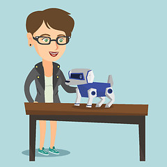 Image showing Young caucasian woman playing with a robotic dog.