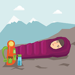 Image showing Woman sleeping in a sleeping bag in the mountains.