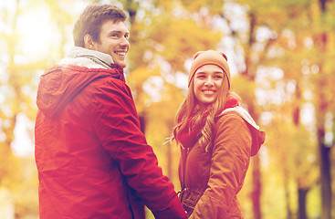 Image showing happy young couple walking in autumn park