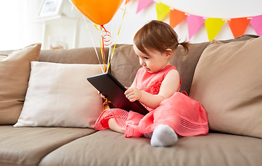 Image showing baby girl with tablet pc on birthday party at home