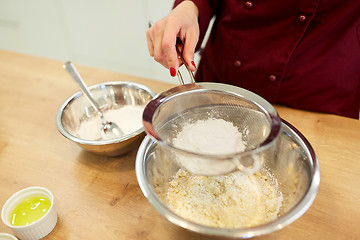 Image showing chef sifting flour in bowl making batter or dough