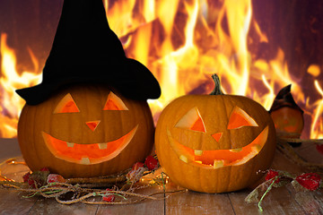 Image showing carved halloween pumpkins on table over fire