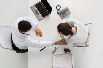 Image showing doctor with laptop and woman patient at hospital