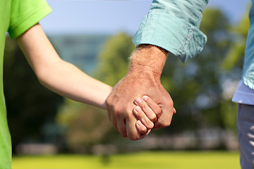 Image showing senior man and child holding hands