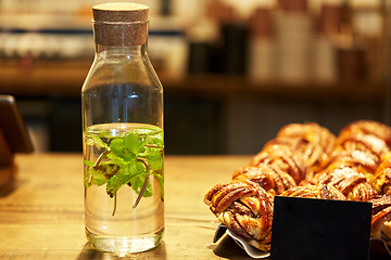 Image showing fruit water in bottle and buns at grocery store