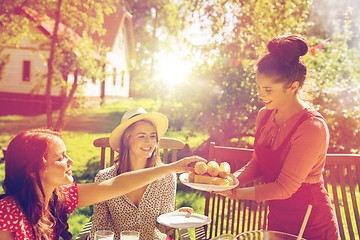 Image showing happy friends having dinner at summer garden party