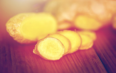 Image showing close up of ginger root on wooden table