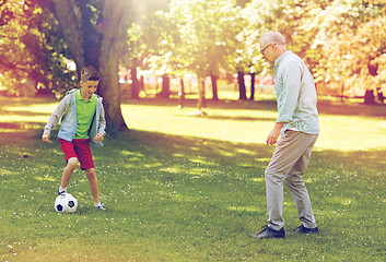 Image showing old man and boy playing football at summer park