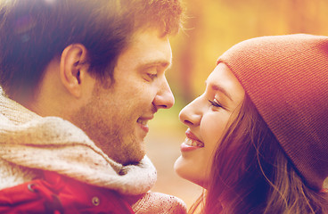 Image showing close up of happy young couple kissing outdoors