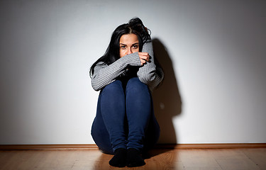 Image showing unhappy woman crying on floor at home