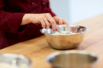 Image showing chef with flour in bowl making batter or dough