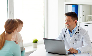 Image showing woman with baby and doctor with laptop at clinic