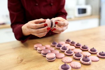 Image showing chef sandwiching macarons shells with cream