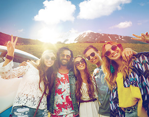 Image showing hippie friends over minivan car showing peace sign