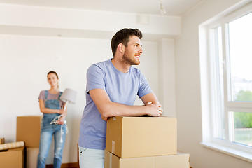 Image showing happy couple with boxes moving to new home