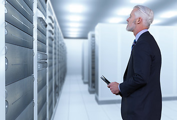 Image showing Senior businessman in server room