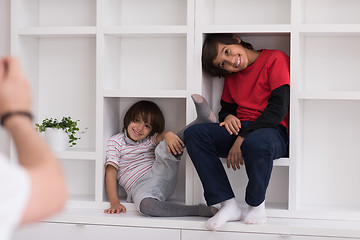 Image showing young boys posing on a shelf