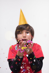 Image showing kid blowing confetti