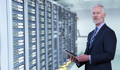 Image showing Senior businessman in server room