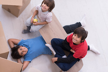 Image showing boys with cardboard boxes around them top view